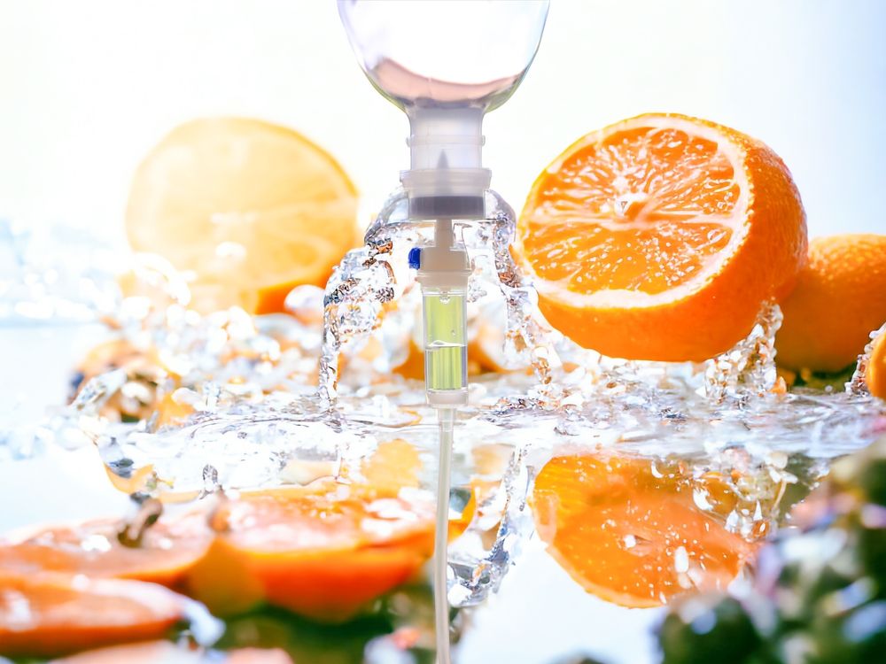IV drip with oranges, water splashing, a bright, citrusy scene.