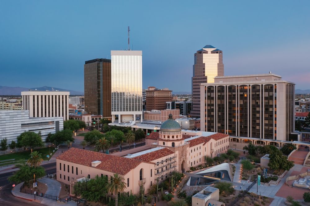 Downtown Tucson cityscape with buildings and dome at dusk.