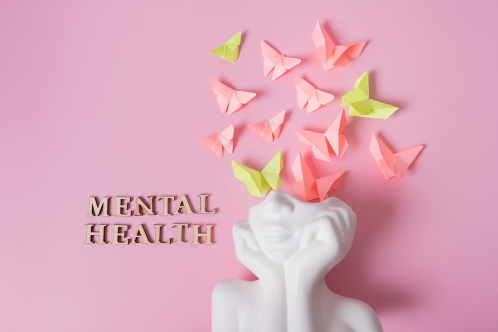 White statue with origami butterflies emerging from its head, the word
