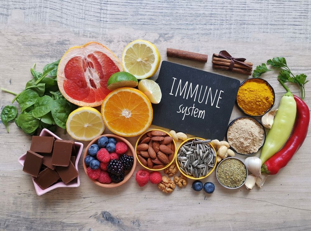 Arrangement of fruits, nuts, spices, and chocolate around a chalkboard reading