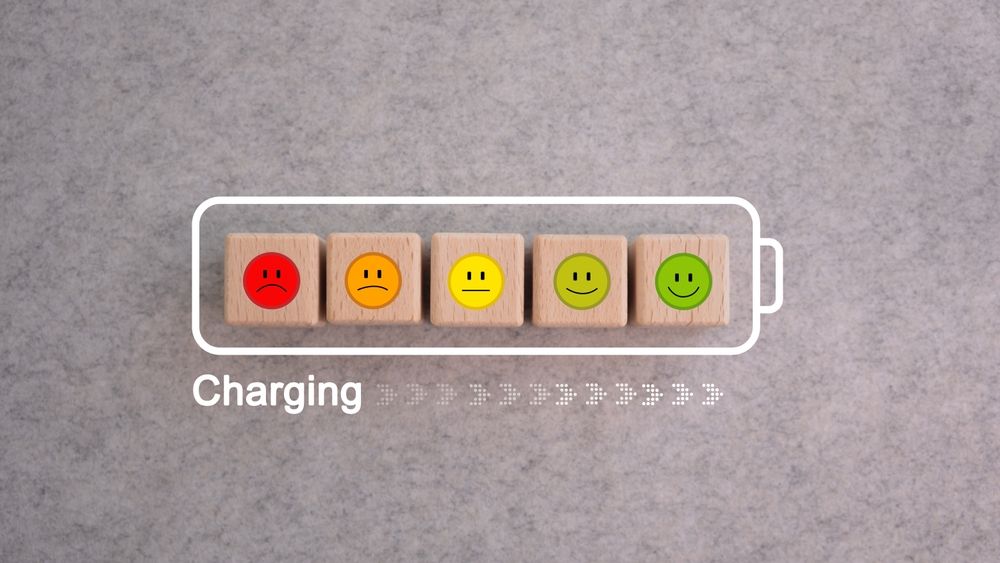 Battery charging progress with smiley faces from red to green.