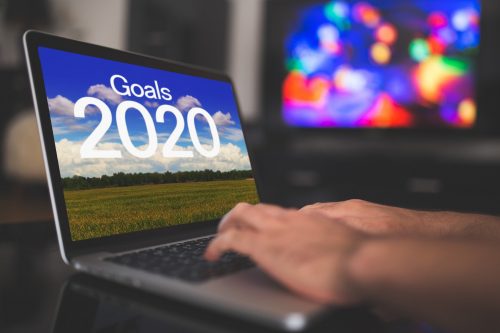 Person typing on laptop, screen displaying