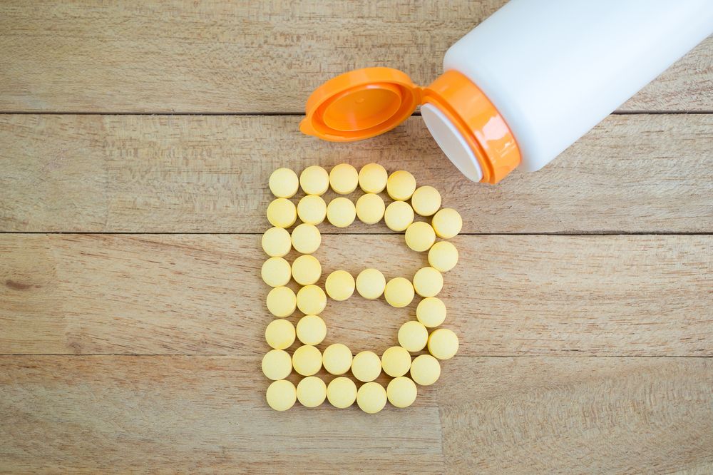 Yellow pills arranged in the shape of a letter
