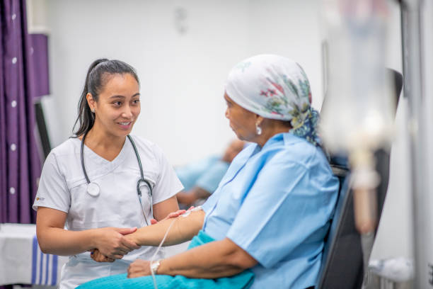 Nurse comforts patient receiving IV treatment in a hospital room.