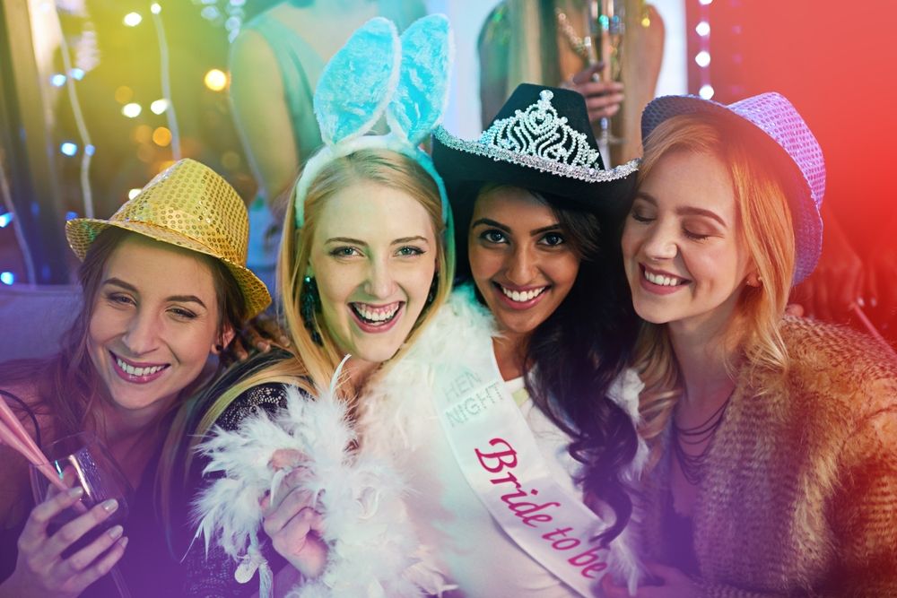 Group of smiling people wearing party hats and a