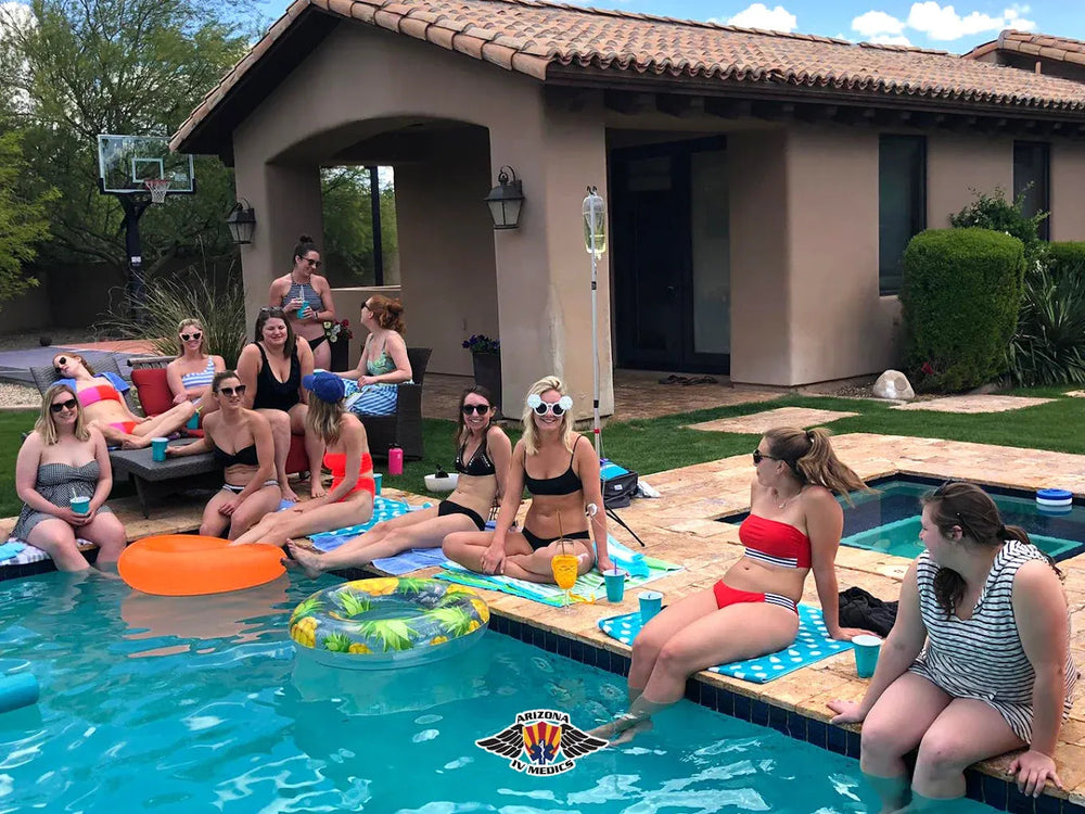 Scottsdale group receiving mobile IV therapy beside a private pool