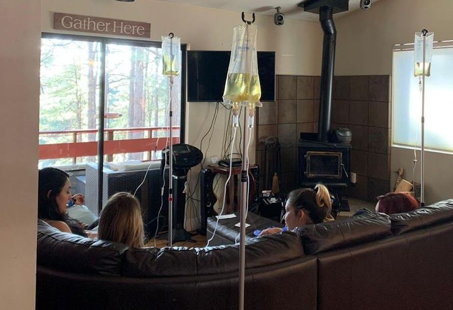 Four clients receiving mobile IV therapy from AZ IV Medics at an Arizona cabin