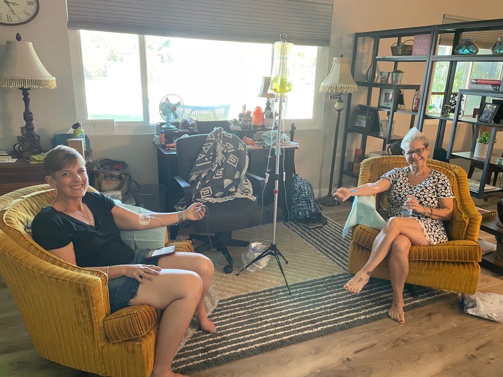 Two clients receiving mobile IV therapy from AZ IV Medics at an Arizona home